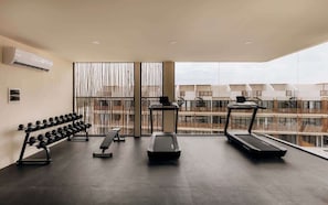 A modern gym with treadmills, dumbbells, and a bench. - B'olay Tropical Samsara Condo Beach Club Access (Tulum)