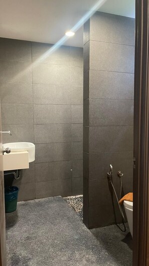 A bathroom with grey tiled walls, a white sink, and a shower area. - Arwana Perhentian Bluestar (Pulau Perhentian Besar)