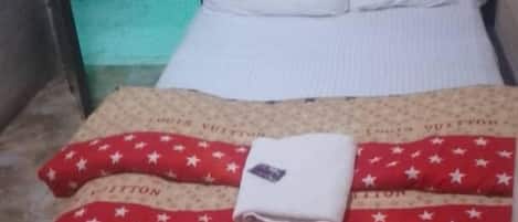 Desk, laptop workspace, bed sheets