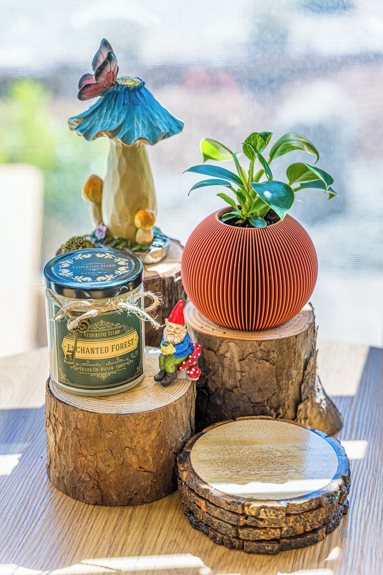 A rustic wooden table with a decorative gnome figurine, a potted plant, a tin can, and a round wooden coaster.