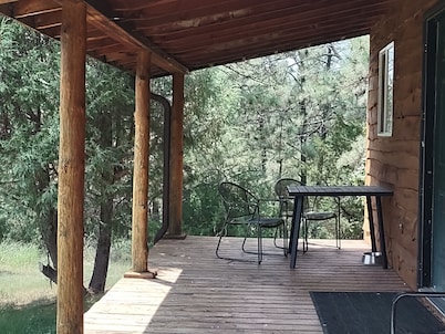One of two rustic cabins nestled in Rosebud Sicangu Lakota Oyate pine forest.