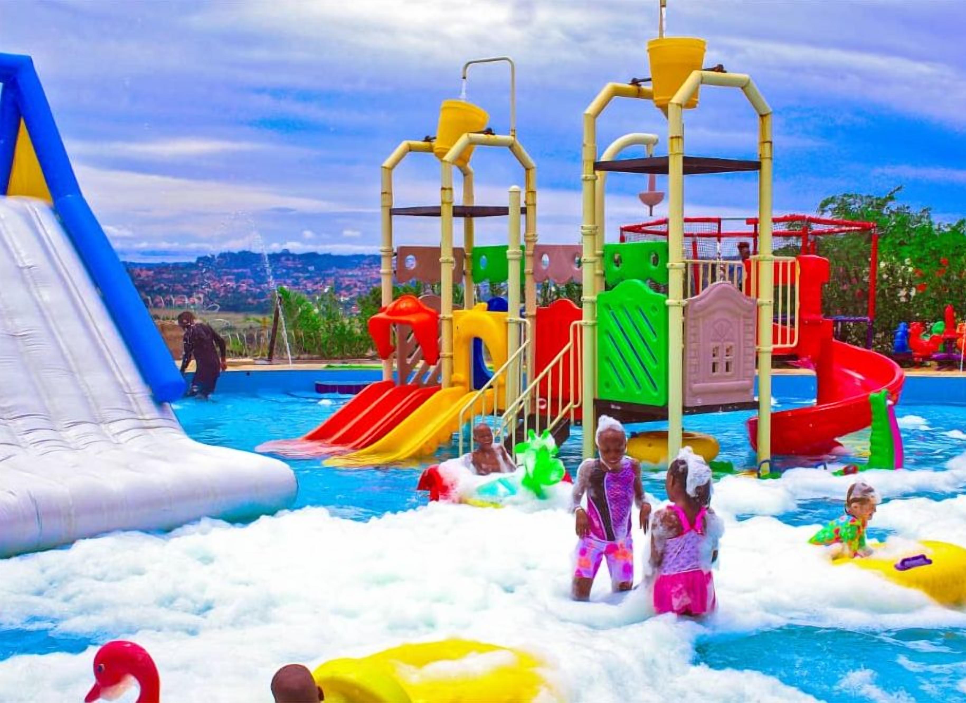 A water park with inflatable slides, a wave pool, and a play structure.