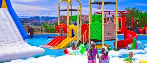 A water park with inflatable slides, a wave pool, and a play structure.
