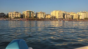 A waterfront cityscape with buildings and a crowd by the water. - Prestige Beach Apartament Durres (Durres)