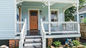 A two-story house with a porch, a front door, and a mailbox. - Downtown Mobile: Pet Friendly + 5m Walk (Mobile)