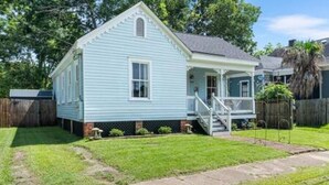 A single-story house with a front porch and a small front yard. - Downtown Mobile: Pet Friendly + 5m Walk (Mobile)