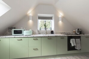 A kitchen with a window, a microwave, a toaster, and a sink. - Luxury 1-Bed Annex on Rodborough Common (Rodborough Common)