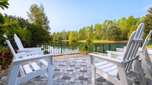 Outdoor seating with a view of a lake and trees. - Caribe Cove Charm - For 8! (Kissimmee)