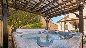 A hot tub under a pergola with a clear view of the surrounding area. - Spacious Home in Prime Location | Pool, Spa, Games (Glendale)
