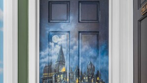 A door with a painted night scene of a castle and a moon. - Storybook Summit: Theater, Arcade, Spa, and more! (Big Bear Lake)