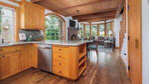 Une cuisine spacieuse avec des meubles en bois, un lave-vaisselle encastré et un grand îlot central.