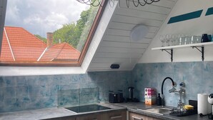 A kitchen with a skylight, a sink, and wooden cabinets. - Family friendly Private pool Quiet location, own garden Walking distance to Lake Balaton (Balatonföldvár)