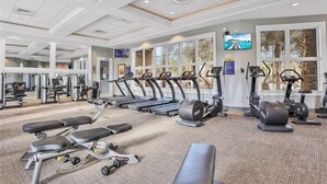 A gym with treadmills, elliptical machines, and weight benches. - Solterra Bliss - Resort Stay for 13 w/ Pool, Hot Tub & Game Room (Davenport)
