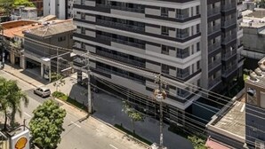 A multi-story building with a modern architectural design, featuring balconies on each floor.