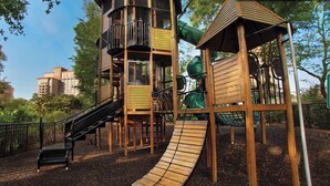 A playground with a slide, climbing structures, and a bench. - Myrtle Beach's Marriott Vacation Club, spacious 2BR, 2BA villas, ocean view
 (Myrtle Beach)