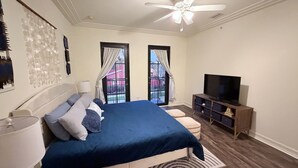 A bedroom with a bed, a TV stand, and a ceiling fan. - SW FL Vacation Paradise! Minimum 1 week stay, long term renters welcome.  (Fort Myers)