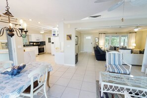 A spacious living area with a dining table, chairs, a sofa, and a TV. - Waterfront, Private Pool, Walk to Tigertail Beach, Best of Marco! (Marco Island)