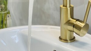 A gold faucet with water running into a white sink. - Cozy Studio downtown Carson, near Tahoe/Reno (Carson City)