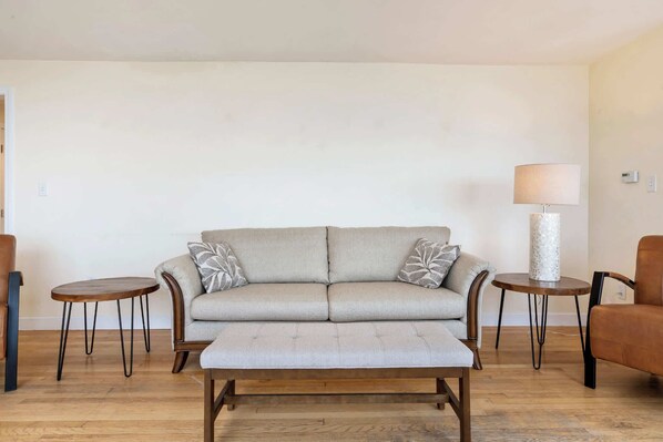 A living room with a sofa, two side tables, and a lamp. - Oceanfront Ping Pong 1 Min Walk to Beach Pets Welcome (York Beach)