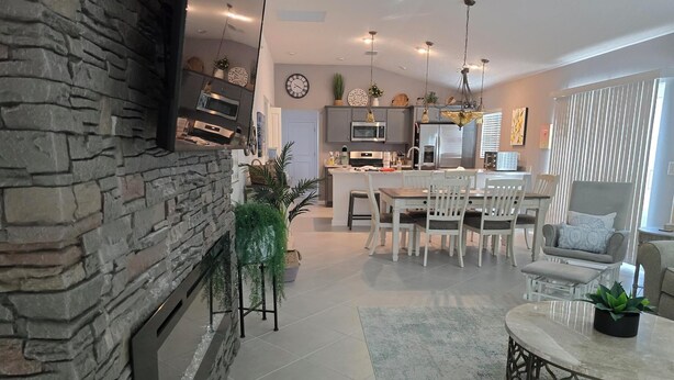 A modern kitchen with granite countertops, stainless steel appliances, and a central island. - Beautiful, well appointed, 3-bed house in DeLuna - 2 Kings! (The Villages)