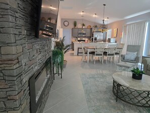 A modern kitchen with granite countertops, stainless steel appliances, and a central island.