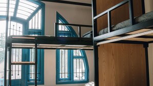 A bunk bed room with a skylight, wooden walls, and a window with blue shutters. - Quiri Hostel Hanoi (Hanoi)