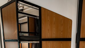 A bathroom with a large mirror, two sinks, a hairdryer, and a wooden cabinet. - Quiri Hostel Hanoi (Hanoi)