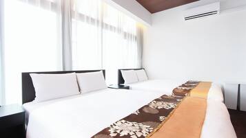 A hotel room with two beds, a large window with sheer curtains, a white air conditioning unit, and a brown decorative runner on the bed.