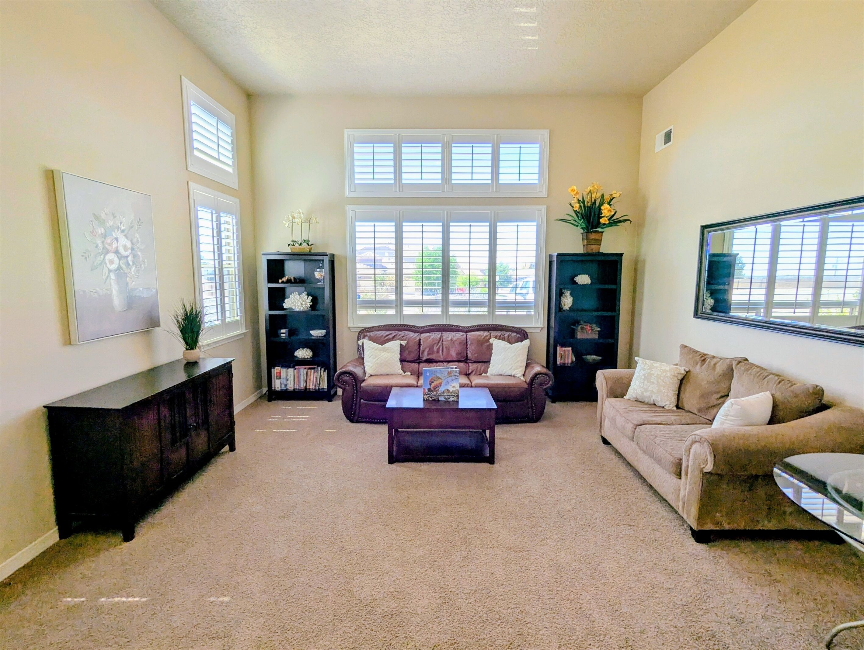 A living room with two sofas, a coffee table, and two bookshelves.