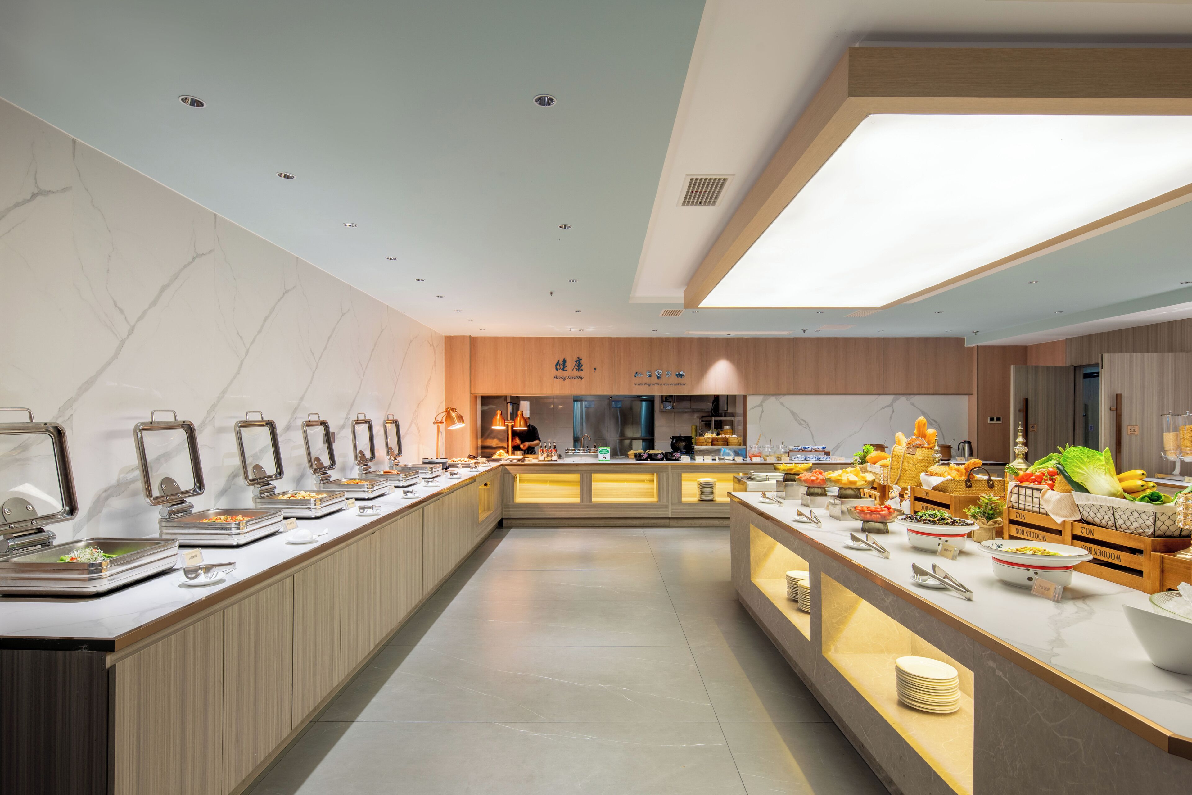 A modern buffet setup with multiple serving stations, a central island, and a clean, minimalist design.