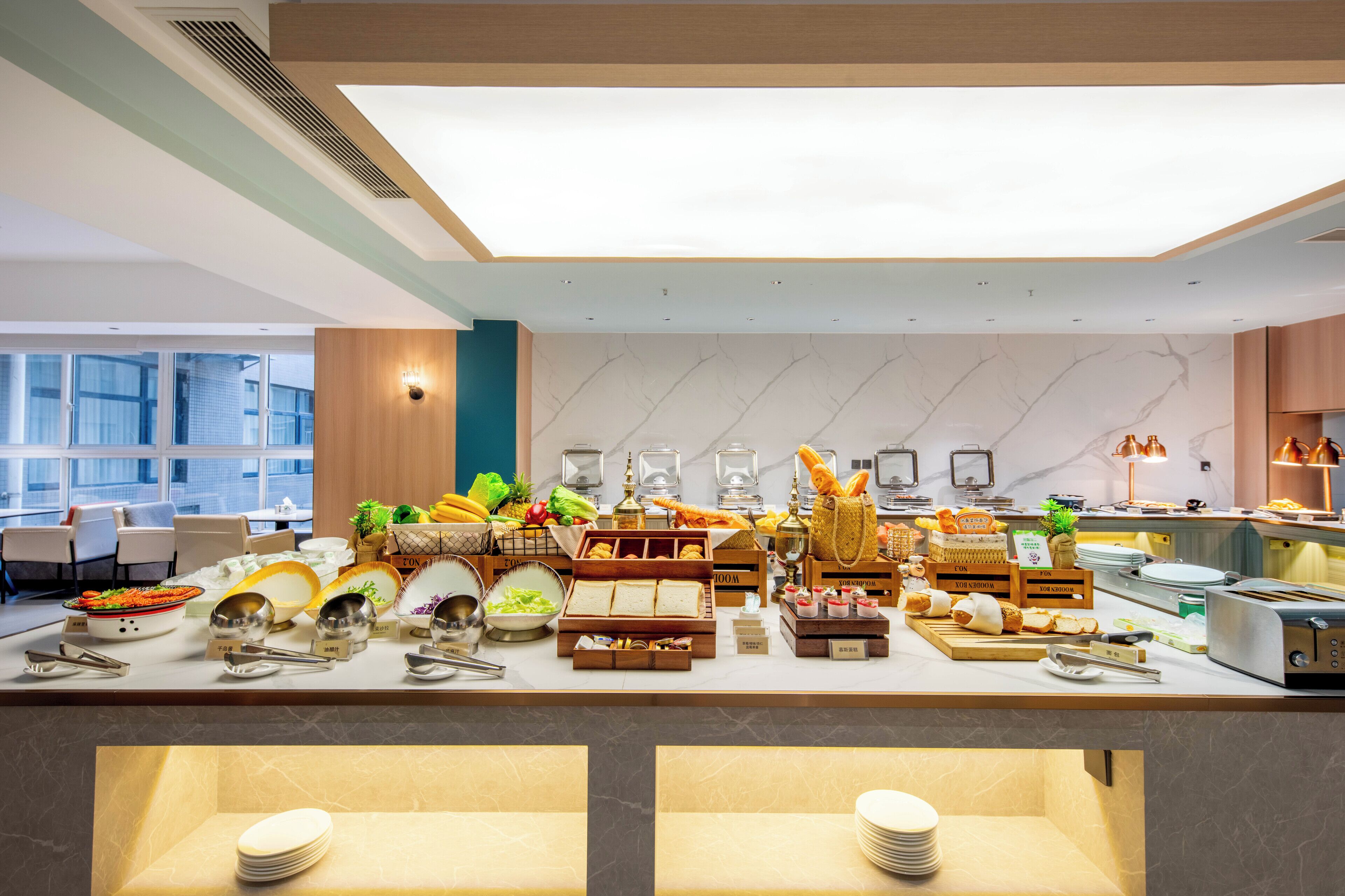A buffet setup with various food items and utensils.