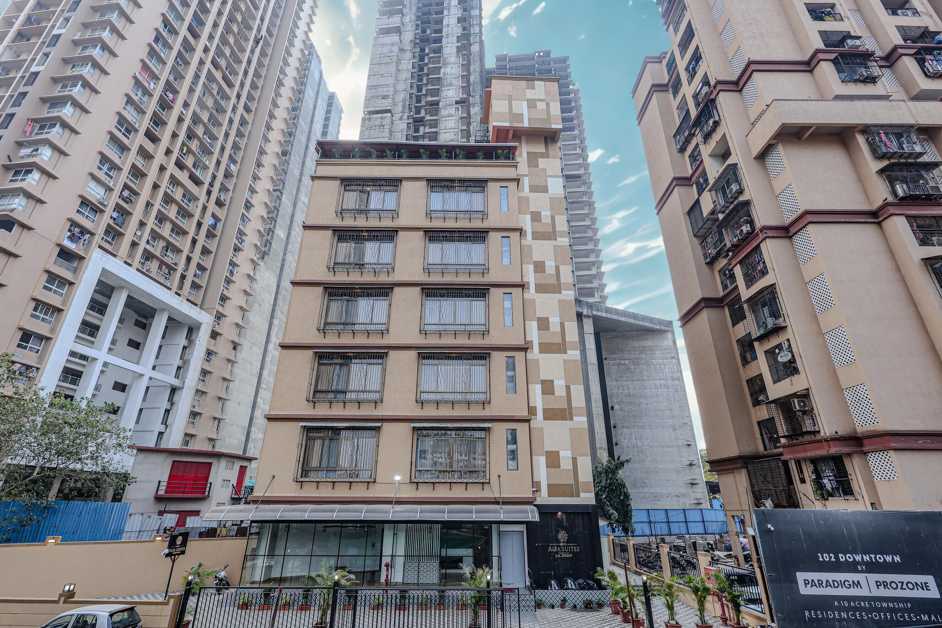 A multi-story hotel with a modern design, featuring balconies and large windows.