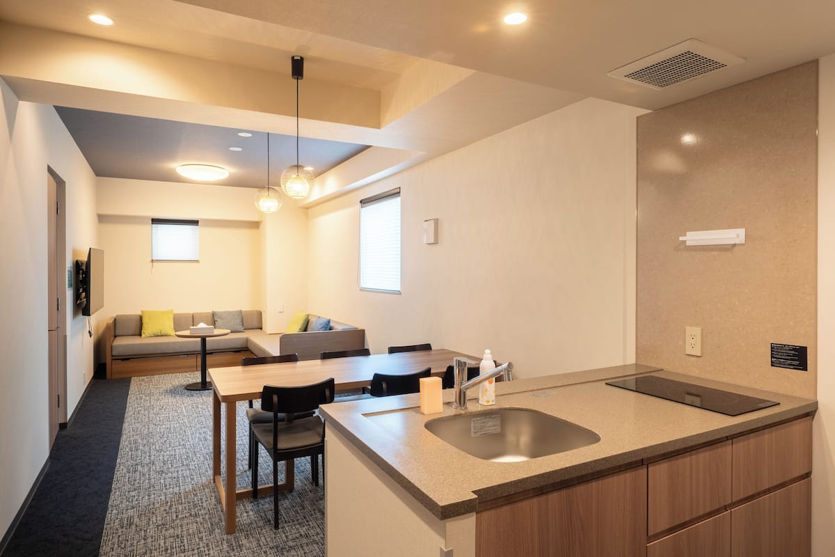 A compact kitchen with a sink, countertop, and dining area.