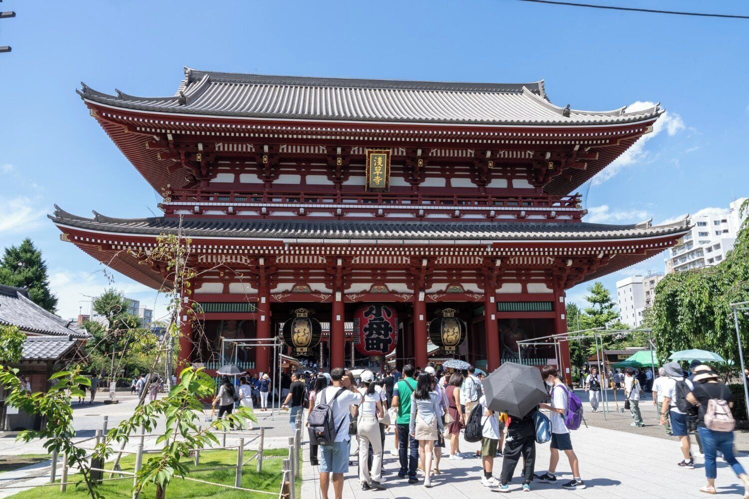 A traditional Japanese building with a multi-tiered roof and red pillars.