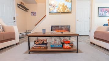 Smart TV, fireplace, books, printers
