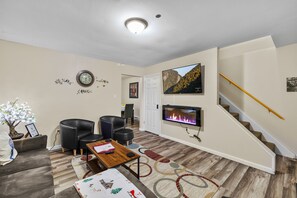 Smart TV, fireplace, books, printers