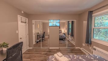2 habitaciones, escritorio y tabla de planchar con plancha