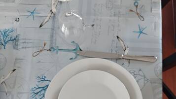A table set with plates, cutlery, and a glass.