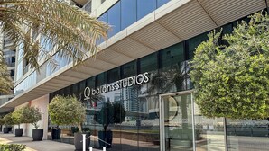 A modern building with a glass facade and the name "Balans Studios" prominently displayed. - LUX 52 42 Deluxe Marina View Suite 3 (Dubai)