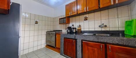 Fridge, microwave, stovetop, cookware/dishes/utensils