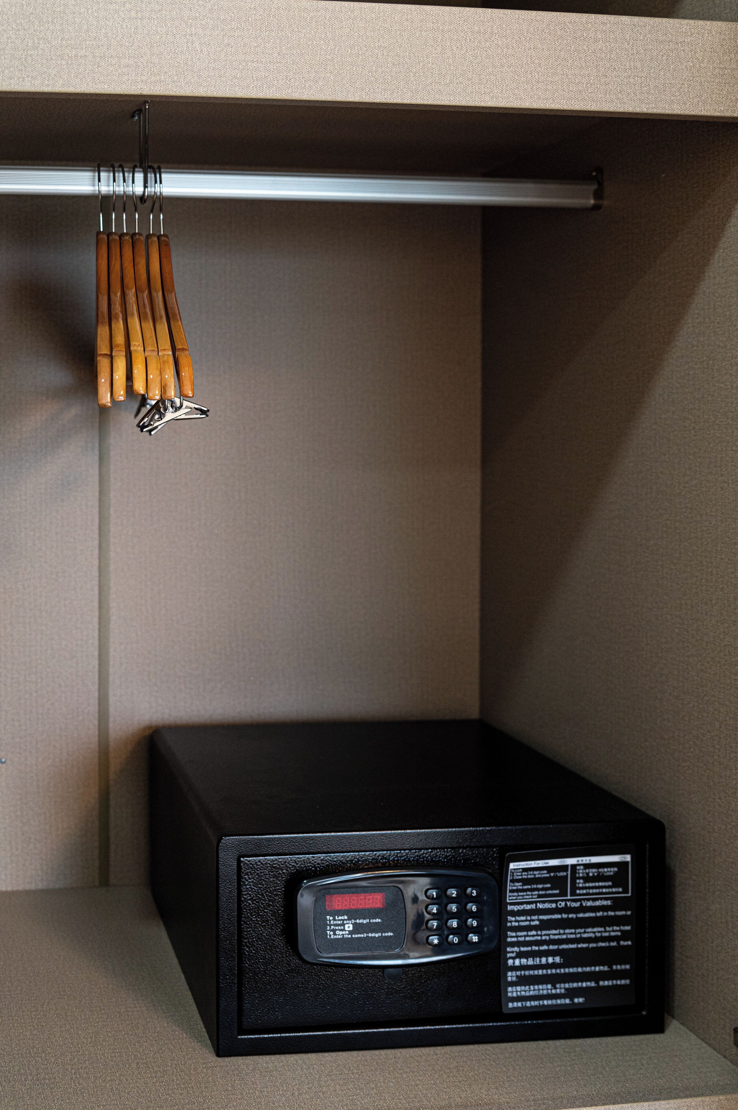 Un dispositivo electrónico negro con pantalla digital y botones, fijado a la pared.