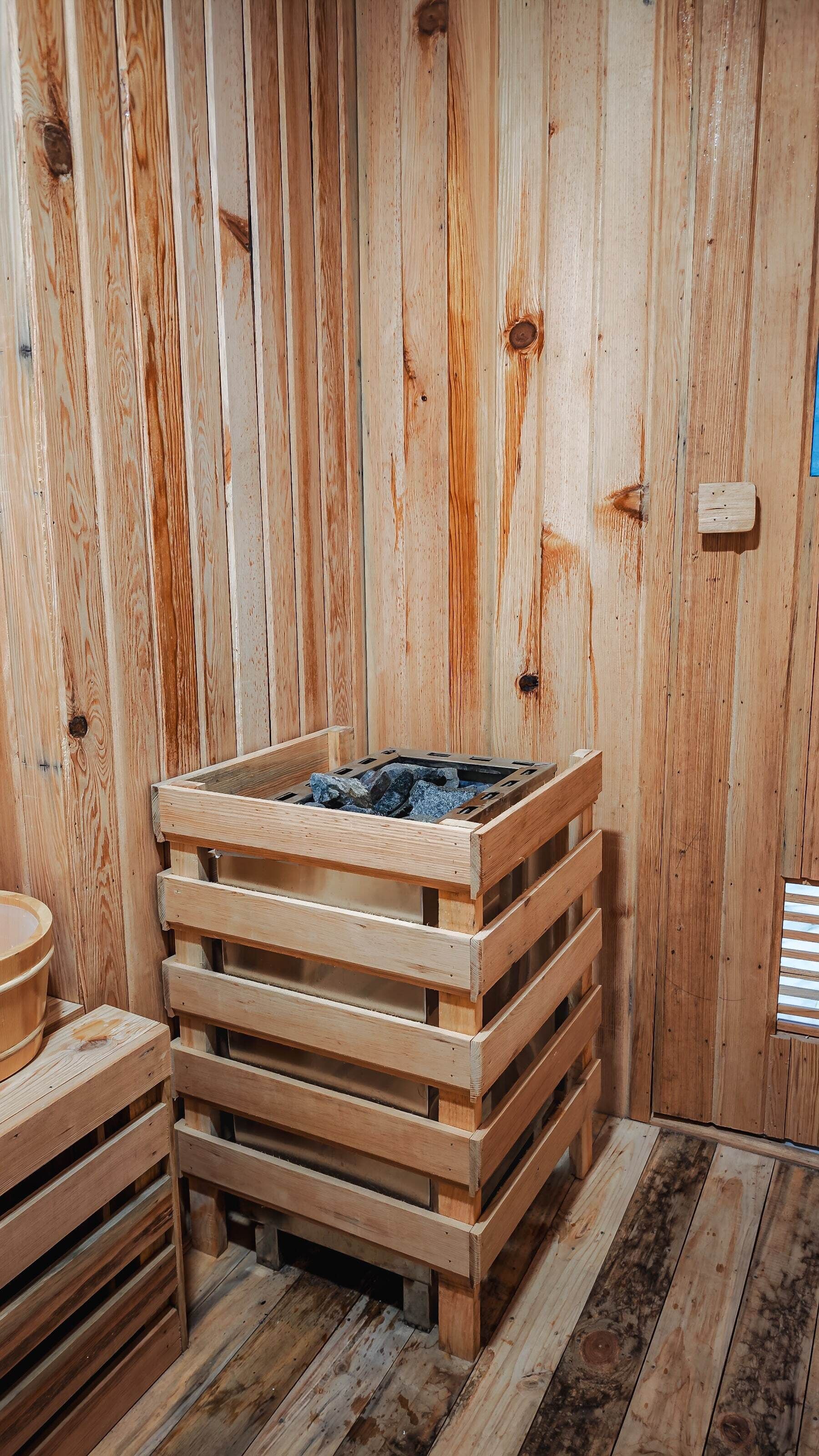 A sauna room with wooden walls and benches.
