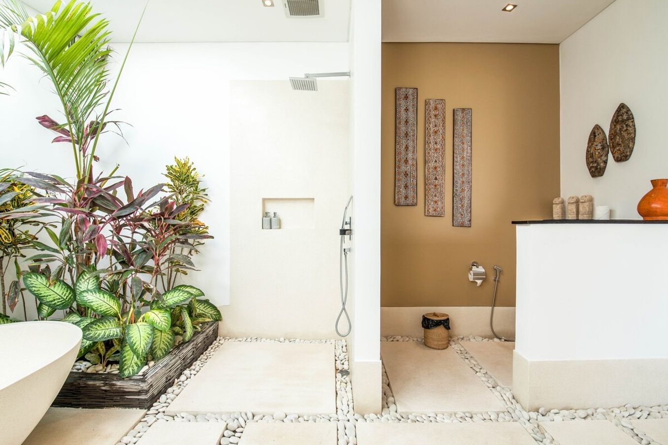 A modern bathroom with a shower, a sink, and decorative wall art.