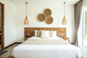 A neatly made bed with a wooden headboard, three woven wall art pieces, and two hanging light fixtures. - Seaside Luxury: 4BR Villa, 400m to Finns, Canggu (Canggu)