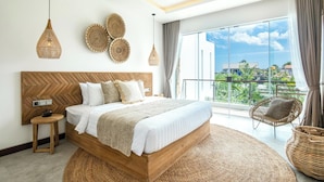 A modern bedroom with a large bed, a wooden headboard, and a view of the city through large windows. - Seaside Luxury: 4BR Villa, 400m to Finns, Canggu (Canggu)