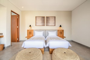 A modern bedroom with two beds, wooden headboards, and wall-mounted lamps. - Brand new Luxury 5 br Villa 200m to Brawah Beach (Canggu)