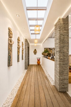 A hallway with wooden flooring, white walls, and a skylight. - Luxurious 5BR Dream Villa, 200m to Berawa Beach (Canggu)