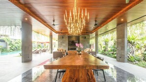 A spacious indoor area with a large wooden table, comfortable seating, and a modern chandelier. - Stylish 5BR Private Villa, Central Seminyak (Seminyak)