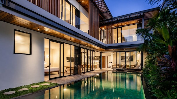 A modern house with a swimming pool, large windows, and a well-maintained garden. - Stylish 5BR Beach Villa, 200m in Boho Canggu (Munggu)