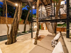 A modern outdoor living area with a pool, lounge seating, and a staircase. - Chic 2-br Villa With Pool, 800m to Canggu Beach (Canggu)